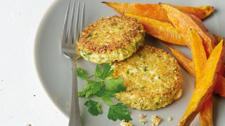 Quinoa Patties with Cauliflower and Feta served on a grey plate with sweet potato wedges