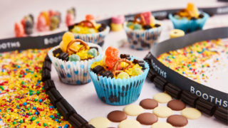 Chocolate Tiffin Race Cars surrounded by sprinkles and chocolate buttons