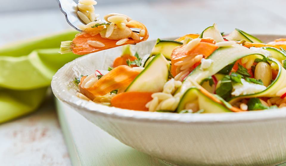 Orzo Pasta Salad served in a white bowl