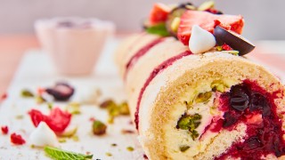 Summer Berry Roulade topped with mini meringues and fresh berries