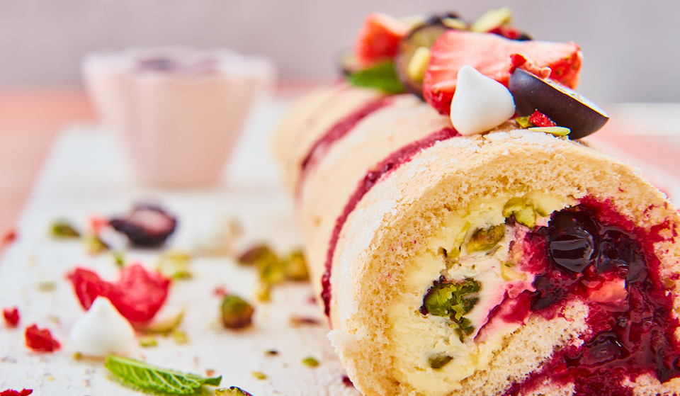 Summer Berry Roulade topped with mini meringues and fresh berries