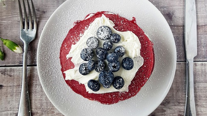 Red Velvet Pancakes with a Cream Cheese Filling on a plate, topped with blueberries