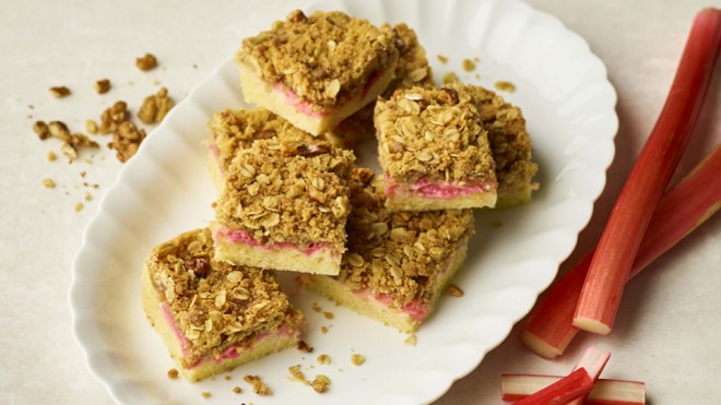 Rhubarb Traybake cut into portions and arranged on a white plate