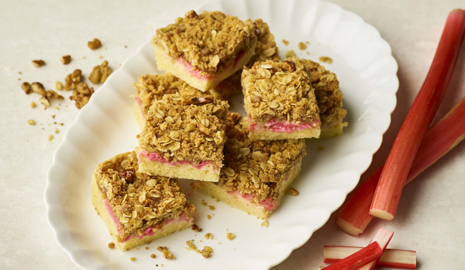 Rhubarb Traybake cut into portions and arranged on a white plate