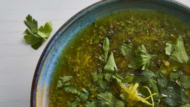 Salsa Verde served in a blue bowl and topped with cracked black pepper