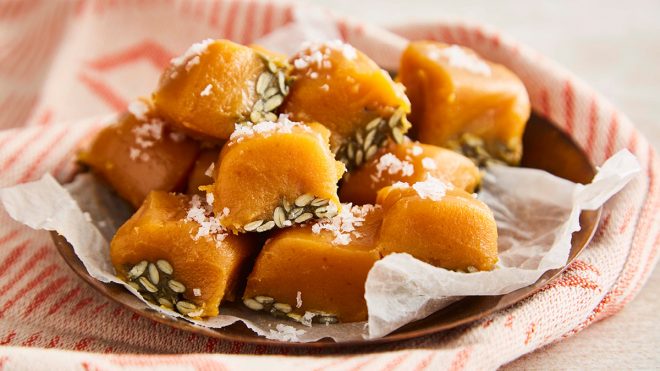 Salted Caramel Pumpkin Fudge served on baking parchment on top of a plate