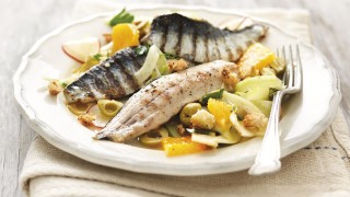 Sicilian Style Sardines with Orange and Fennel Salad served on a white plate topped with green olives and dill