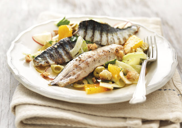 Sicilian Style Sardines with Orange and Fennel Salad served on a white plate topped with green olives and dill