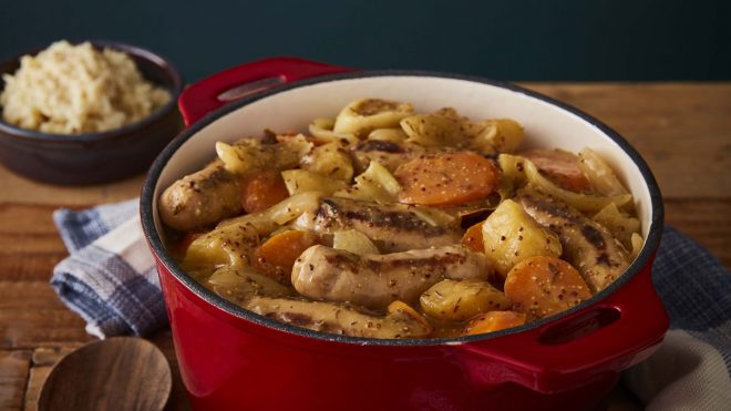 Slow Cooker Sausage Casserole served in a casserole dish on top of a wooden table