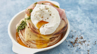 Savoury Buckwheat Pancakes served in a white dish, topped with a poached egg