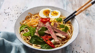 Steak Ramen Bowl served in a blue dish with chopsticks