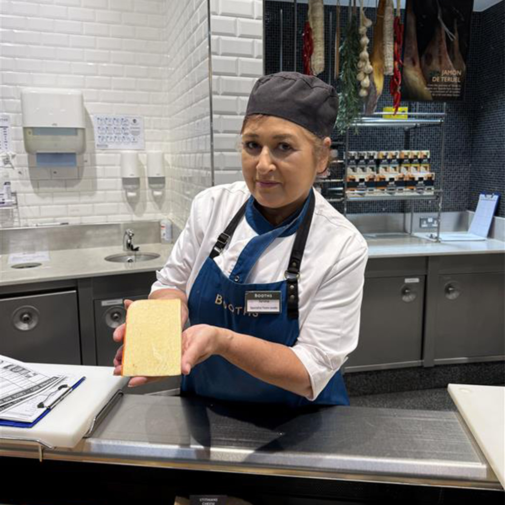 Image of a Booths colleague holding Booths Special Reserve cheese