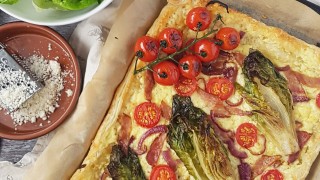 Stuffed Crust BLT Tart on baking parchment topped with vine tomatoes
