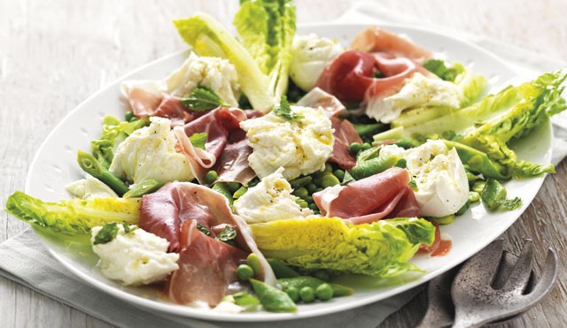 Summer Green Salad with Mozzarella and Parma Ham served on a white plate