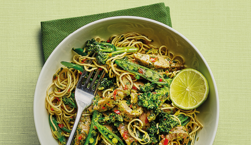 Thai Beef and Broccoli Stir Fry served in a white bowl with a wedge of lime