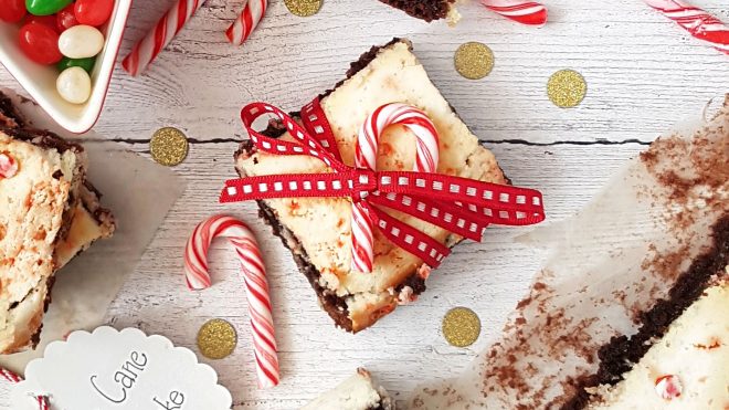 Cane Cane Cheesecake Brownies tied with a bow on a white wooden table