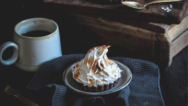 Chocolate Lemon Meringue Tartlets served on a rustic style plate