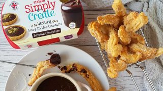 Cinnamon Churros served in a wire basket with dipping chocolate