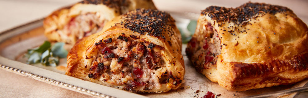 Turkey, Stuffing and Cranberry Sausage Rolls served on a white tray