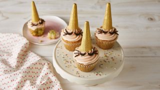 Unicorn Cupcakes served on a white baking dish surrounded by sprinkles