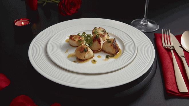 Pan Fried Scallops served on a white plate