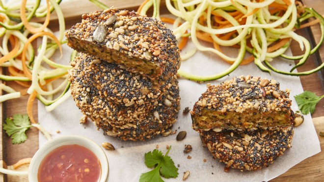 Mini Veggie Sliders served on a wooden boards with spiral cut vegetables and sweet chilli dipping sauce