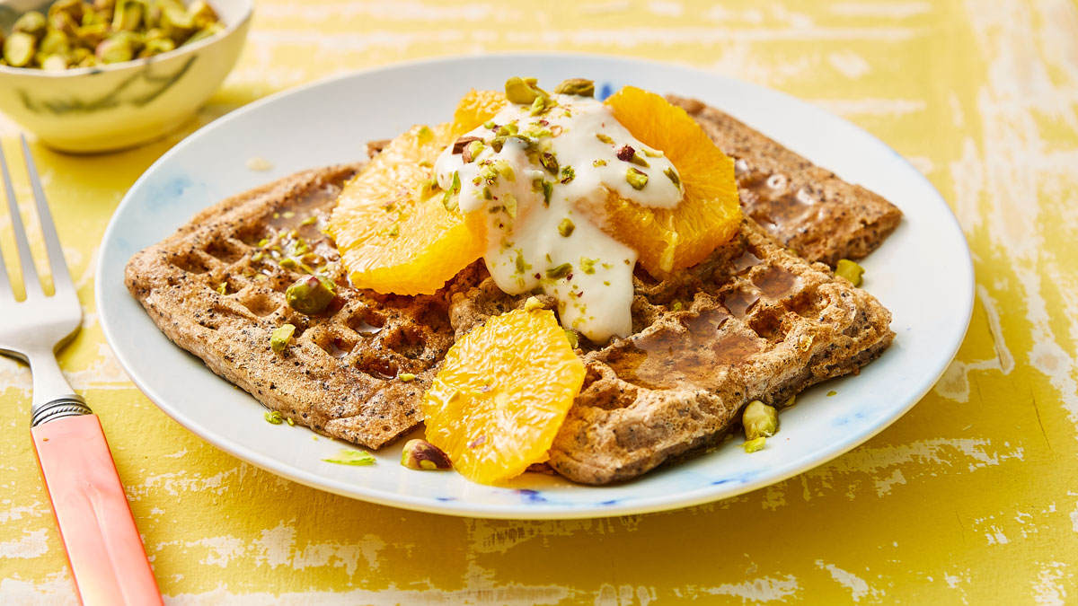 Gluten Free Vegan Waffles topped with dairy free yoghourt and pistachios