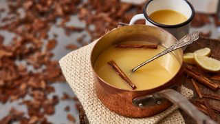 Warmed Mulled Apple and Gin served on a copper pan with cinnamon sticks