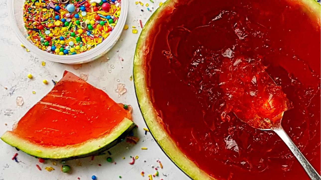 Watermelon Jelly served in a watermelon and surrounded with sprinkles